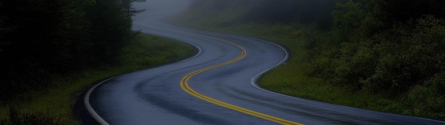 Wet asphalt road in the mountains